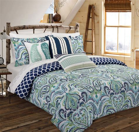 The comforter and shams reverse to a classic blue and white shirting stripe, which is repeated in the matching European shams and ruffled pillow cover. . Blue comforter queen